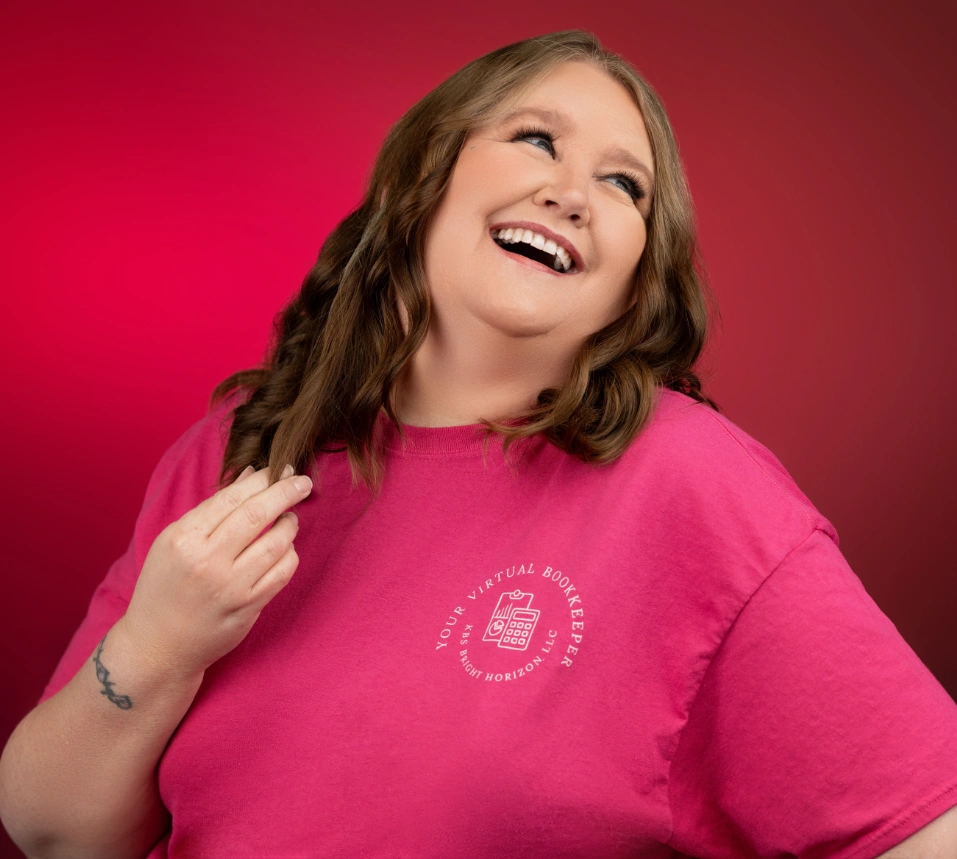 Karen Bowen smiling in a pink “Your Virtual Bookkeeper” T-shirt on a pink background.